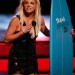 Britney Spears sosteniendo la tabla de surf agradeciendo a sus fans