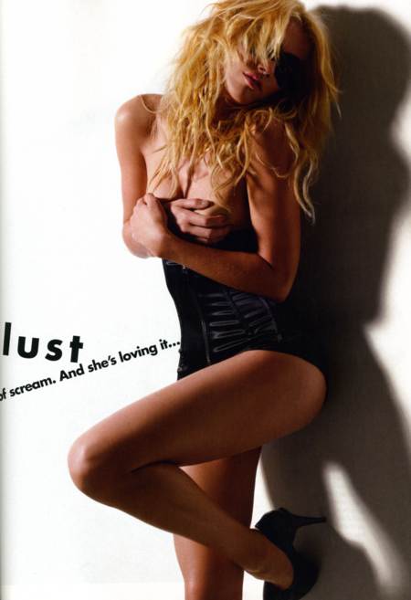 Amber Heard posando con un corset negro cubriendose los senos con las manos