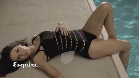 Kate Beckinsale mirando a la camara en una piscina con un traje de baño negro